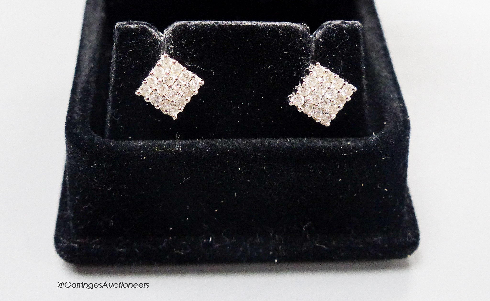 A modern pair of 18ct white gold and diamond encrusted square ear studs, 5mm, gross weight 2.7 grams.